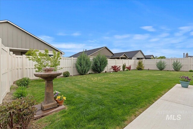 view of yard with a patio and a fenced backyard