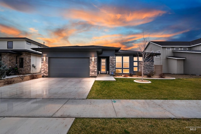 view of front of house with a yard and a garage