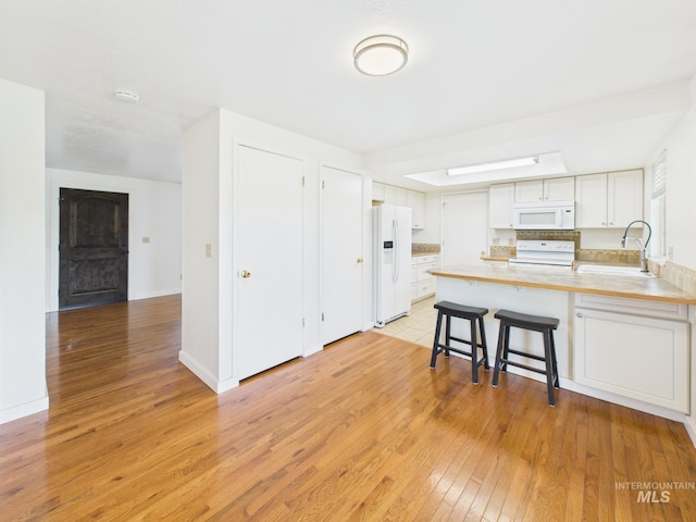 1673 Thomas, Emmett, ID 83617 - kitchen with white appliances, a peninsula, light wood-style flooring, and light countertops