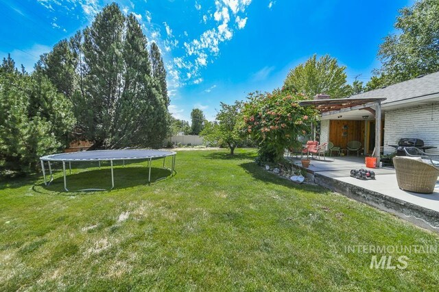 2844 Parke Circle Dr, Boise, ID 83705 - view of yard featuring a trampoline and a patio