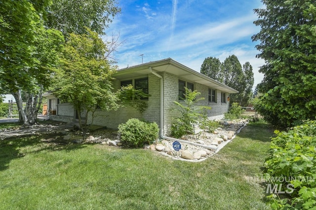 2844 Parke Circle Dr, Boise, ID 83705 - view of side of home featuring brick siding and a lawn