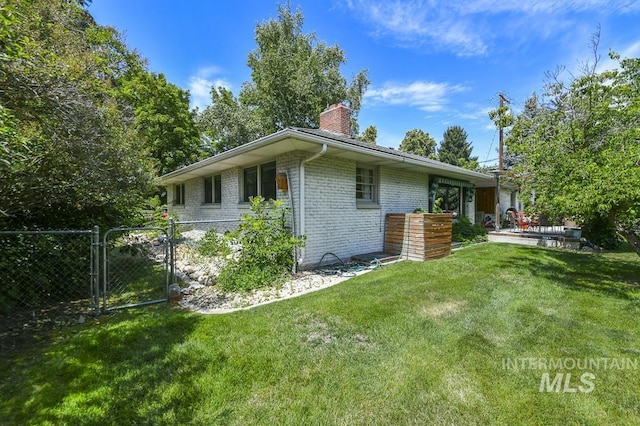 2844 Parke Circle Dr, Boise, ID 83705 - view of property exterior with a chimney, brick siding, and a gate