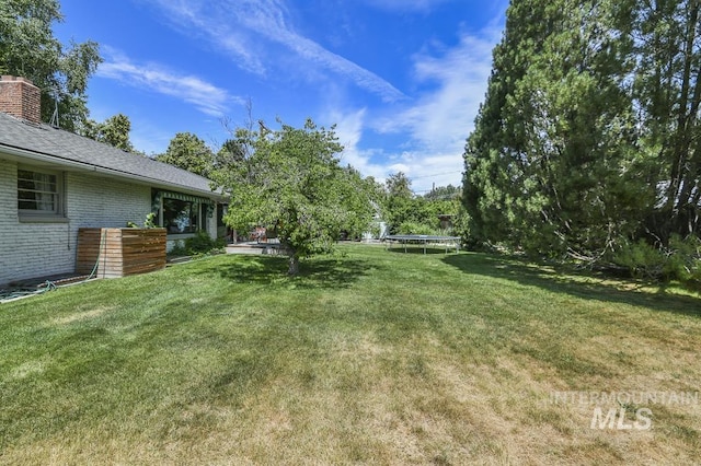 2844 Parke Circle Dr, Boise, ID 83705 - view of grassy yard with a trampoline
