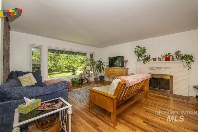 2844 Parke Circle Dr, Boise, ID 83705 - living room with light wood-style floors and a brick fireplace