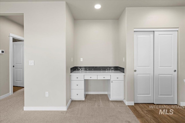 unfurnished office featuring baseboards, light colored carpet, and recessed lighting