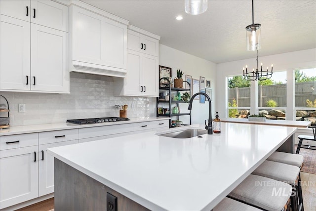 11328 W Campanula Dr, Star, ID 83669 - kitchen featuring a sink, gas stovetop, light countertops, backsplash, and recessed lighting