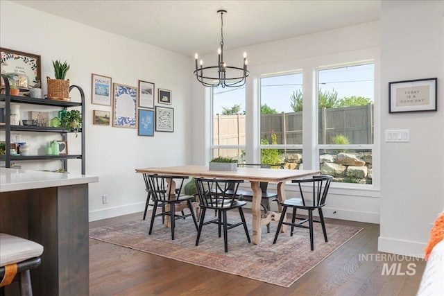 11328 W Campanula Dr, Star, ID 83669 - dining area with a chandelier, baseboards, and dark wood-style floors