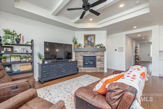 11328 W Campanula Dr, Star, ID 83669 - living area with wood finished floors, a fireplace, a ceiling fan, baseboards, and beamed ceiling