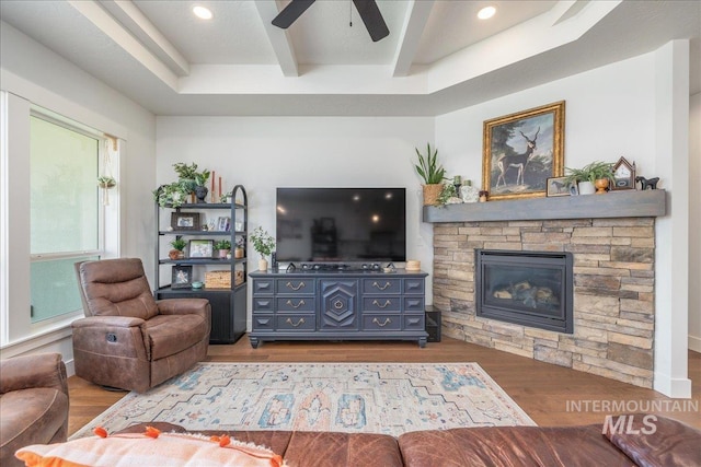 11328 W Campanula Dr, Star, ID 83669 - living area with a stone fireplace, a ceiling fan, wood finished floors, beamed ceiling, and recessed lighting
