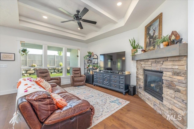 11328 W Campanula Dr, Star, ID 83669 - living room with a fireplace, wood finished floors, ceiling fan, and a tray ceiling