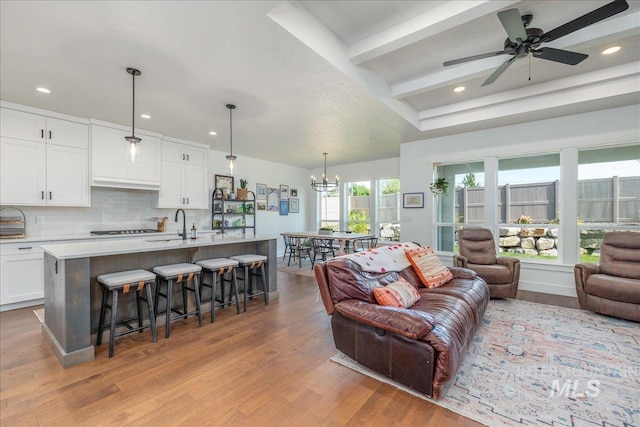 11328 W Campanula Dr, Star, ID 83669 - living area with wood finished floors, a chandelier, recessed lighting, a ceiling fan, and beamed ceiling