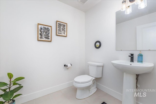 11328 W Campanula Dr, Star, ID 83669 - bathroom with toilet, baseboards, and tile patterned flooring