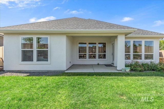11328 W Campanula Dr, Star, ID 83669 - rear view of house featuring a shingled roof, a yard, stucco siding, and a patio area