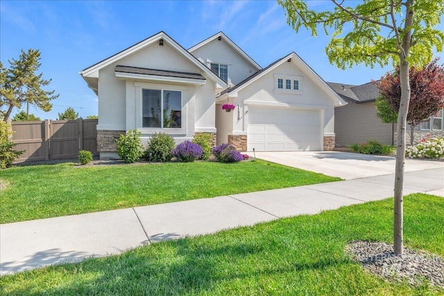 11328 W Campanula Dr, Star, ID 83669 - view of front facade featuring stone siding, concrete driveway, an attached garage, stucco siding, and a gate