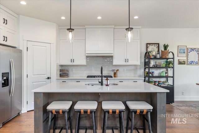 11328 W Campanula Dr, Star, ID 83669 - kitchen with stainless steel fridge, a sink, dark wood-type flooring, white cabinetry, and recessed lighting