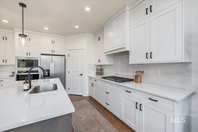 11328 W Campanula Dr, Star, ID 83669 - kitchen featuring appliances with stainless steel finishes, a sink, recessed lighting, and white cabinets
