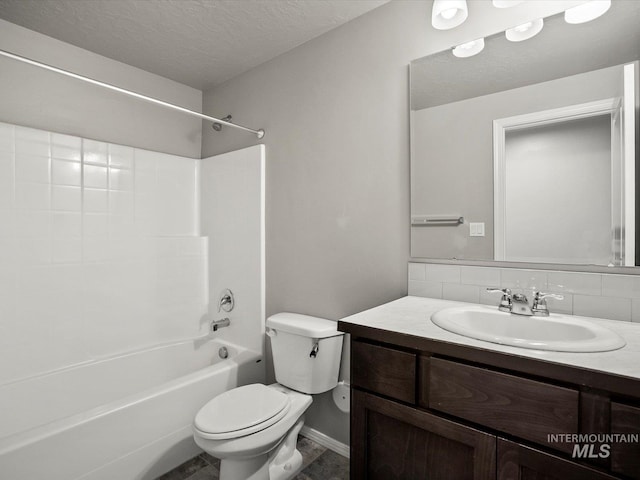 full bath featuring toilet, a textured ceiling, vanity, bathing tub / shower combination, and backsplash