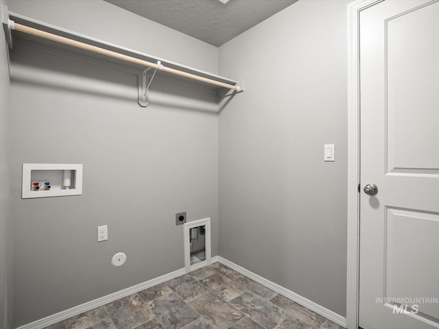 laundry room with baseboards, washer hookup, hookup for an electric dryer, and stone finish flooring
