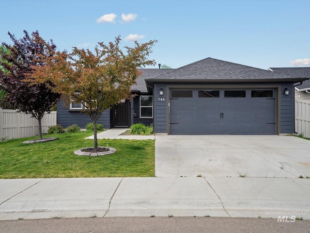 view of front of property featuring an attached garage, concrete driveway, and roof with shingles
