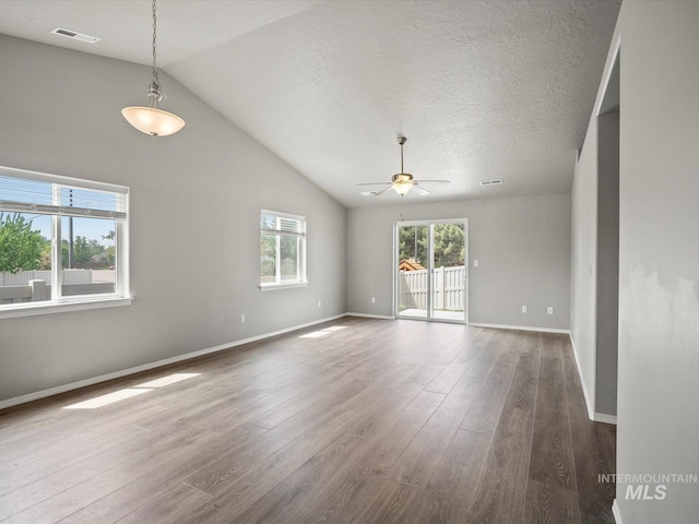 spare room with ceiling fan, wood finished floors, lofted ceiling, and baseboards