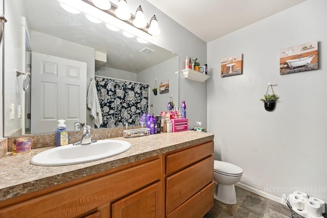 909 Arrow Wood Ct, Twin Falls, ID 83301 - bathroom featuring vanity, toilet, and a shower with shower curtain