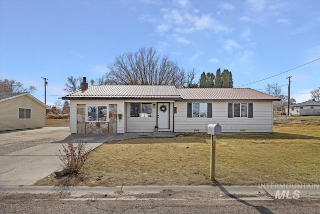 single story home with a chimney, metal roof, crawl space, and a front yard