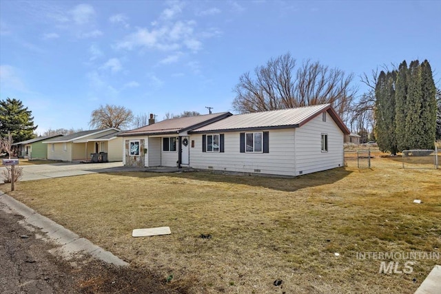 ranch-style home with crawl space, metal roof, and a front yard