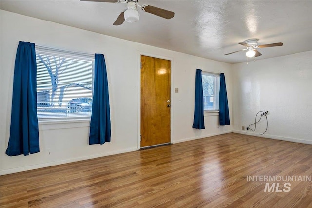 empty room featuring wood-type flooring and ceiling fan