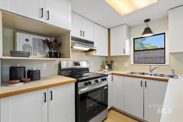 1223 N Mckinney St, Boise, ID 83704 - kitchen featuring light countertops, a sink, under cabinet range hood, and stainless steel electric range oven