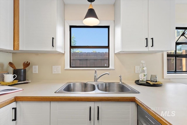 1223 N Mckinney St, Boise, ID 83704 - kitchen featuring a sink, light countertops, white cabinets, and decorative light fixtures