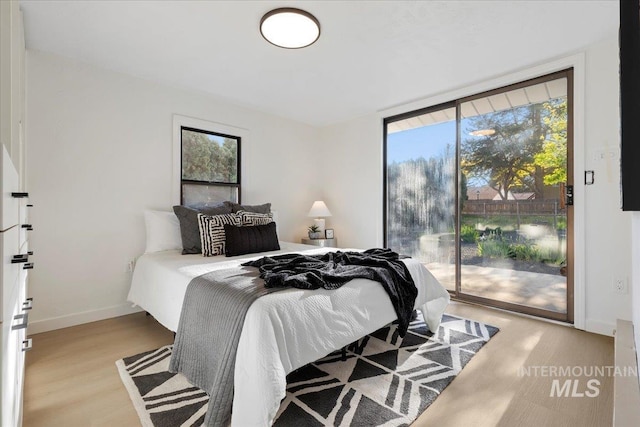 1223 N Mckinney St, Boise, ID 83704 - bedroom featuring access to outside, baseboards, and wood finished floors
