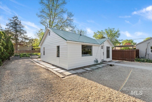 1223 N Mckinney St, Boise, ID 83704 - rear view of property with fence, a patio, and metal roof
