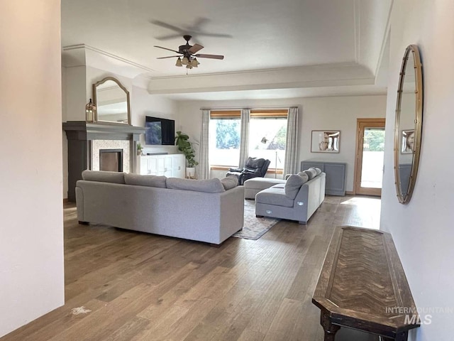 living room with ceiling fan, a healthy amount of sunlight, and wood-type flooring