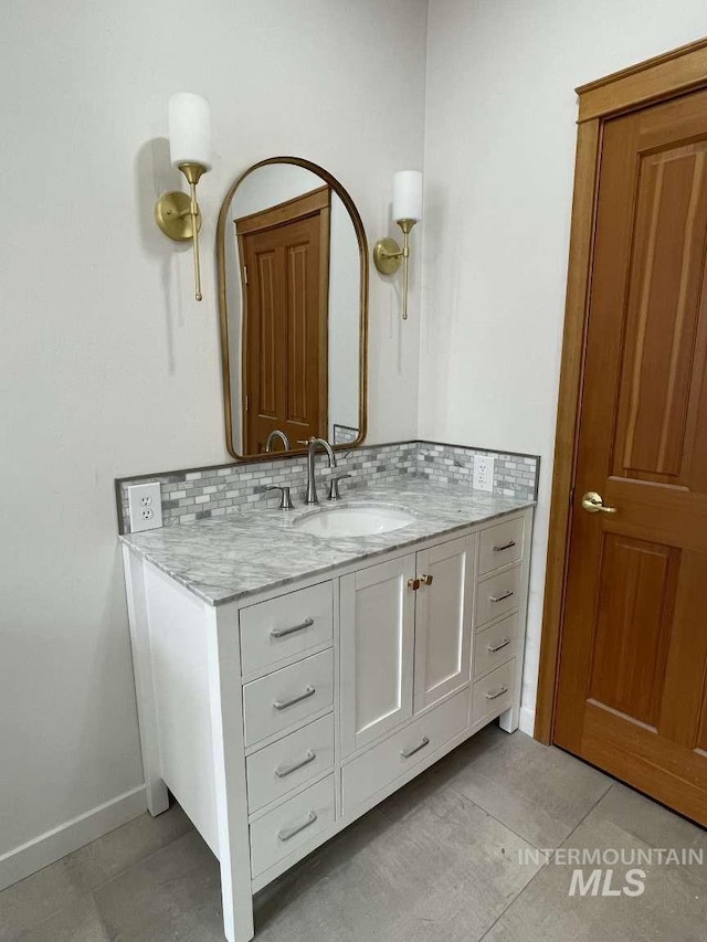 bathroom featuring tasteful backsplash and vanity