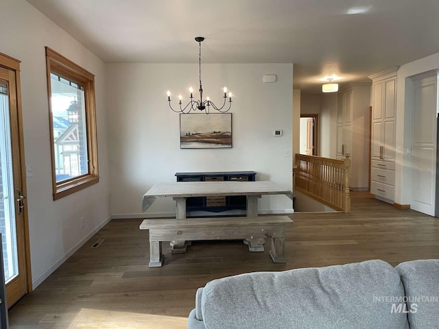 dining room featuring hardwood / wood-style floors and a chandelier