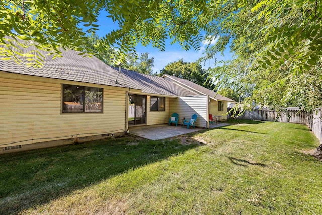 back of property featuring a yard and a patio area