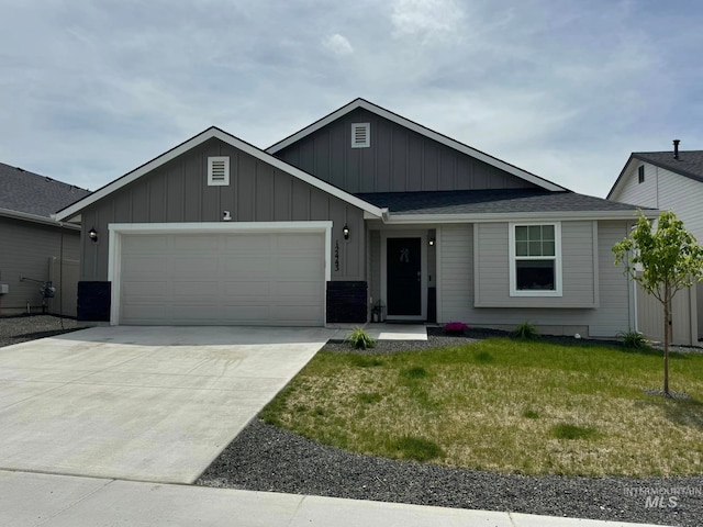 ranch-style home featuring driveway, a front yard, a garage, and board and batten siding