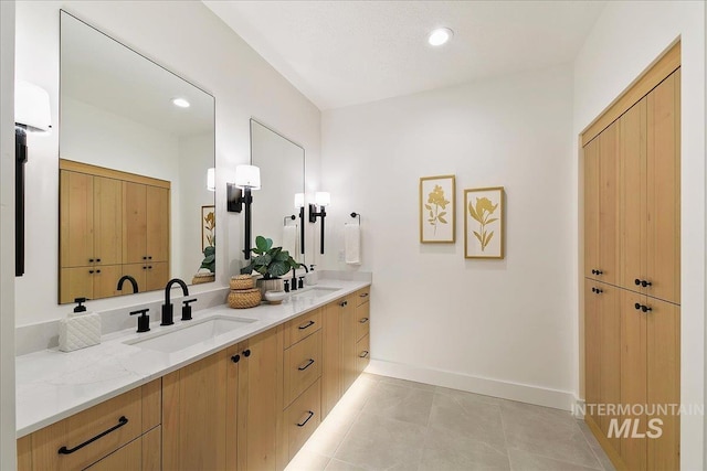 bathroom with tile patterned flooring and vanity