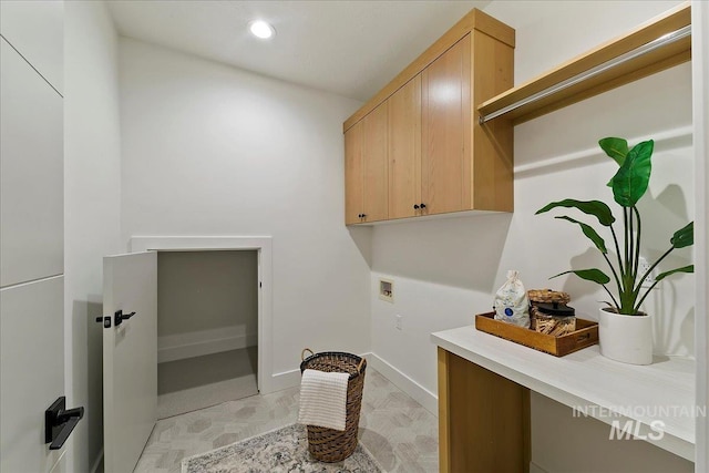 clothes washing area featuring cabinets and hookup for a washing machine