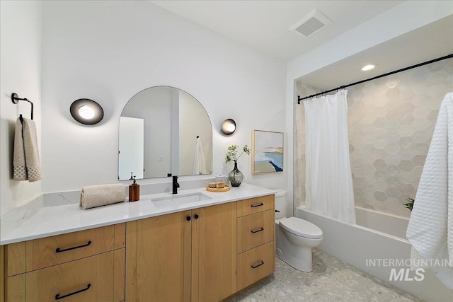 full bathroom featuring vanity, shower / bath combination with curtain, and toilet