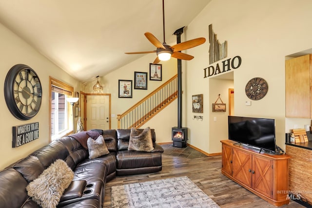 141 Stibnite St Unit 15, Mccall, ID 83638 - living area featuring dark wood-style flooring, ceiling fan, a wood stove, stairs, and baseboards