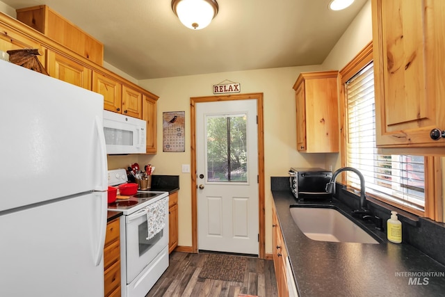 141 Stibnite St Unit 15, Mccall, ID 83638 - kitchen with white appliances, a sink, dark countertops, and dark wood finished floors