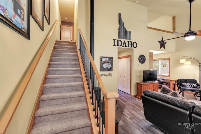 141 Stibnite St Unit 15, Mccall, ID 83638 - staircase featuring wood finished floors, ceiling fan, and a high ceiling