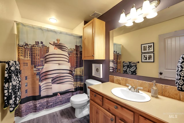 141 Stibnite St Unit 15, Mccall, ID 83638 - bathroom featuring toilet, vanity, wood finished floors, and curtained shower