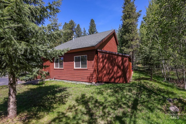 141 Stibnite St Unit 15, Mccall, ID 83638 - view of home's exterior with a lawn and roof with shingles