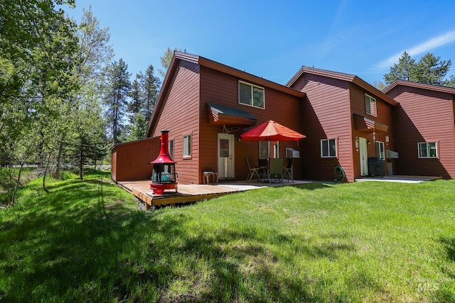 141 Stibnite St Unit 15, Mccall, ID 83638 - rear view of property with a wooden deck, a lawn, and a patio area