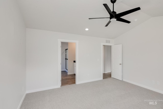 unfurnished bedroom featuring recessed lighting, lofted ceiling, visible vents, baseboards, and carpet flooring