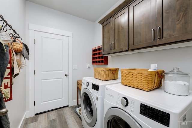 20513 N Glenisla Ave, Boise, ID 83714 - laundry room with baseboards, cabinet space, washing machine and dryer, and light wood-style floors