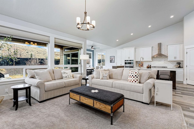 20513 N Glenisla Ave, Boise, ID 83714 - living room with high vaulted ceiling, recessed lighting, light wood-style floors, and ceiling fan with notable chandelier