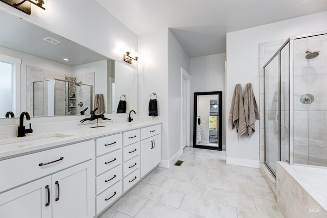 20513 N Glenisla Ave, Boise, ID 83714 - bathroom featuring double vanity, a sink, a stall shower, and visible vents